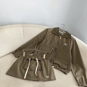 Miu Miu workwear jacket, trousers with low waist pockets, and short skirt set